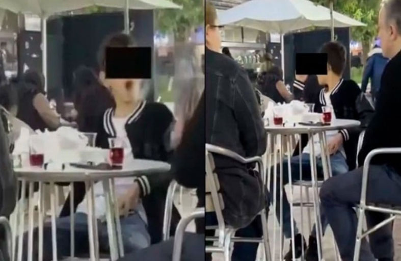 طفل يدخن أمام العامة برفقة والديه