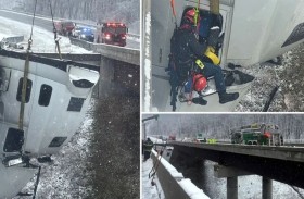 إنقاذ سائق تدلت شاحنته فوق جسر 