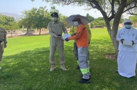 شرطة دبي و روح الاتحاد يوزعان قبعات مظلية على العمال